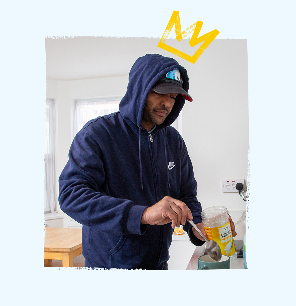 Service user preparing a cup of tea in a cozy kitchen setting