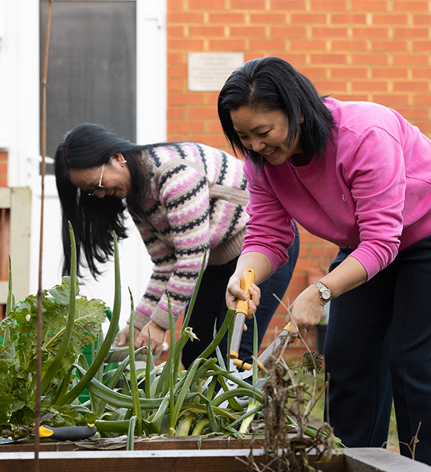 Service workers tending to the garden, planting flowers and maintaining the landscape